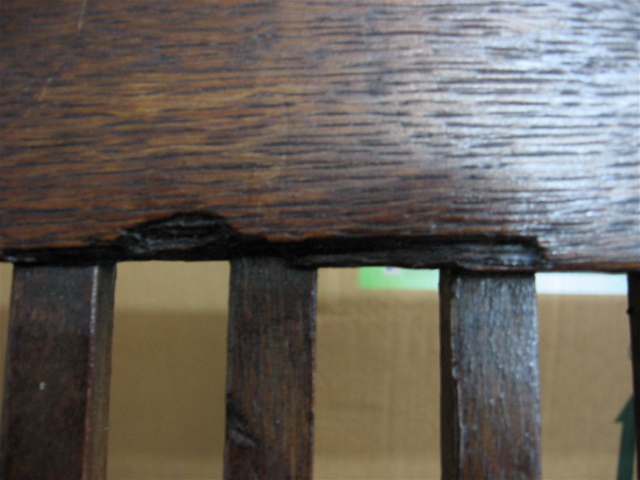 chipped wood on back of bench