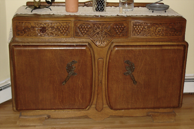 antique buffet with chipped veneer